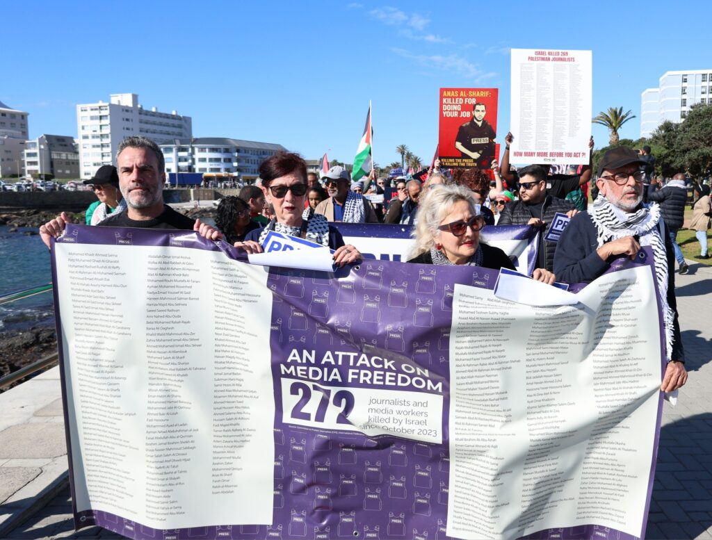 Journalists and supporters marching with banners reading “An Attack on Media Freedom” during a protest against the killing of journalists in Gaza.